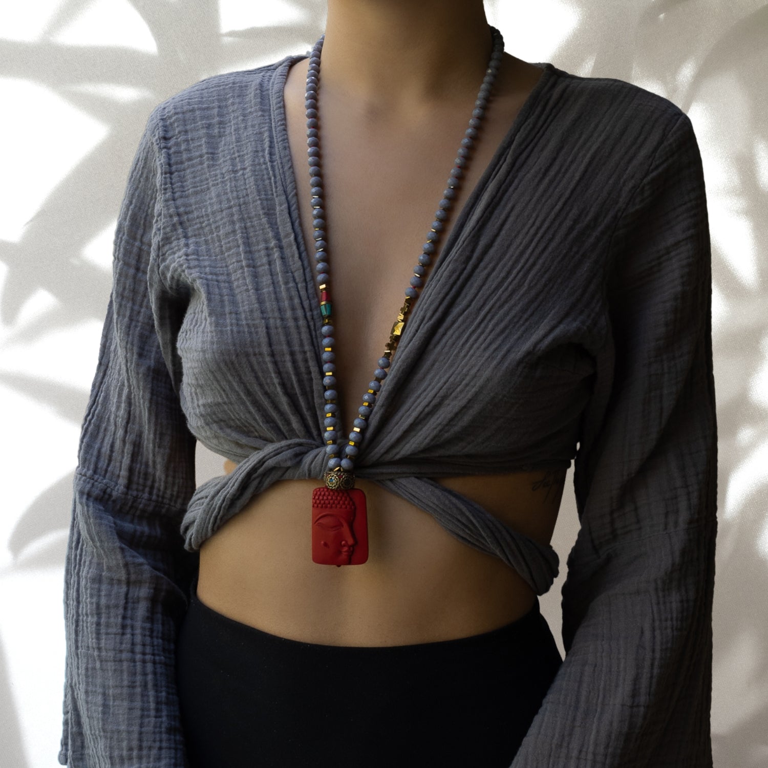 Model wearing Calmness Buddha Necklace with Hand-Carved Pendant and Natural Gemstones