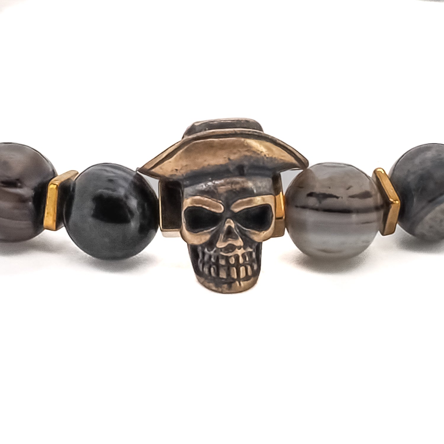 Make a bold statement with the Cowboy Hat Skull Agate Bracelet. Handcrafted with Agate stone beads, gold hematite spacers, and a bronze cowboy hat skull charm, this unique piece of jewelry is perfect for men who want to stand out from the crowd.