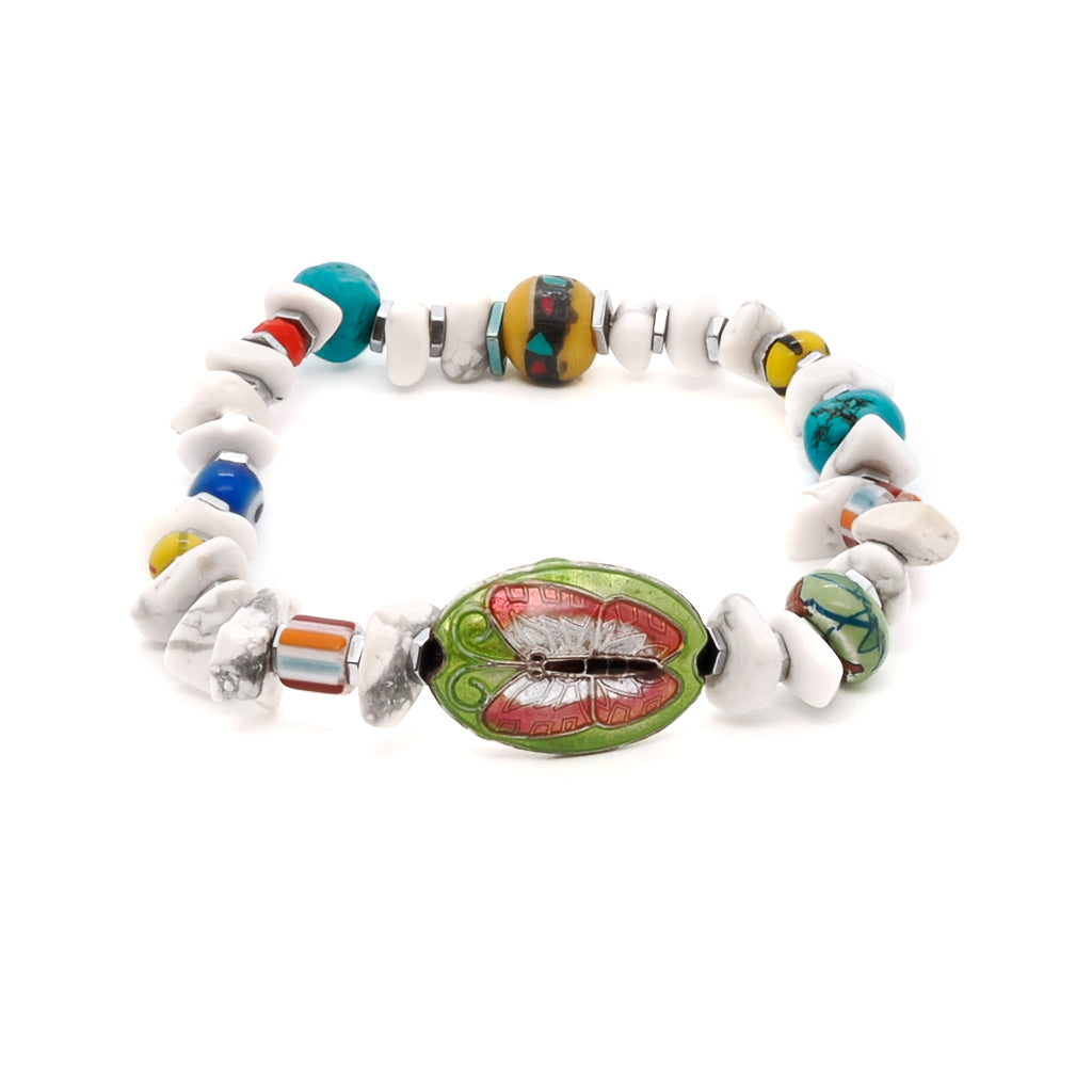 A vibrant and spiritually inspired Cycle of Life Butterfly Bracelet. This handmade bracelet features white nugget howlite beads, colorful African beads, and silver color hematite spacers. The bracelet is adorned with a brass butterfly charm and a glass evil eye bead for added protection.