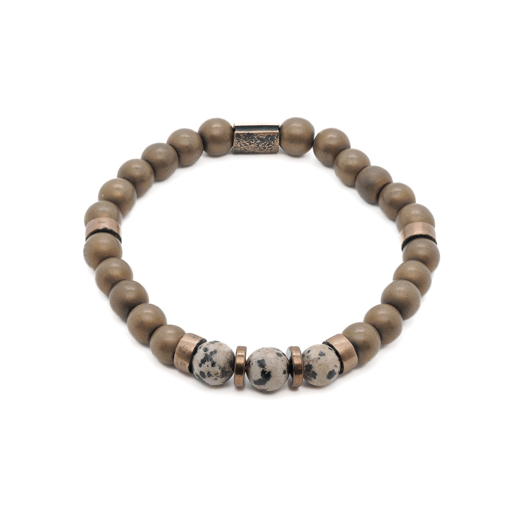 An image showcasing the Dalmatian Jasper Hematite Bracelet, highlighting the combination of Dalmatian jasper beads, hematite beads, and the bronze spacers and spartan accent bead. The bracelet exudes positive energy and grounding vibes.