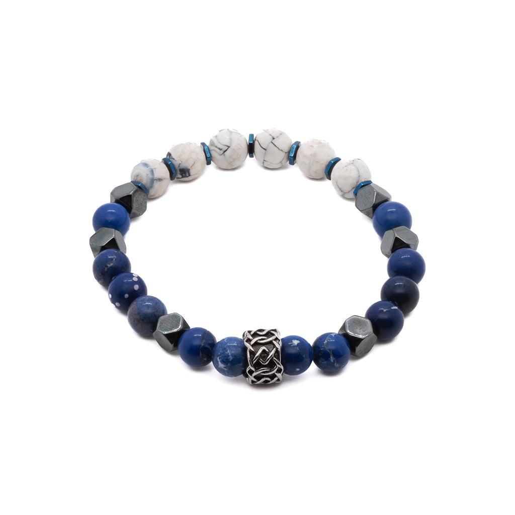 An image showcasing the Deep Blue Bracelet, featuring the beautiful combination of blue jasper stone beads, blue hematite stone spacers, and white howlite stone beads. The bracelet exudes elegance and sophistication with its vibrant blue hues.