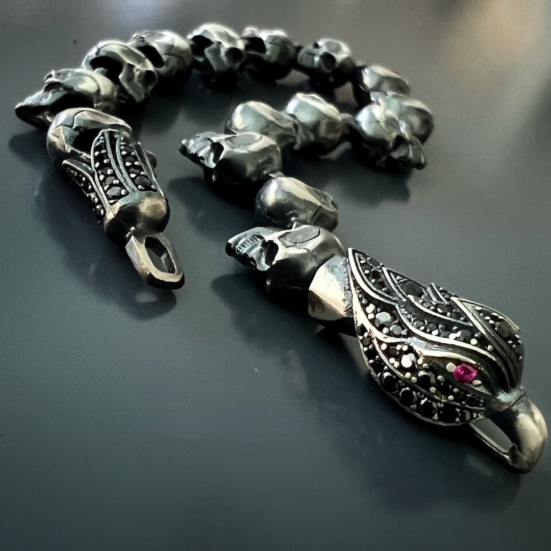 An image showcasing the distinctive design elements of the bracelet, including the hand-carved skulls, the intricate eagle and tulip clasp, and the seamless integration of the zircon stones.
