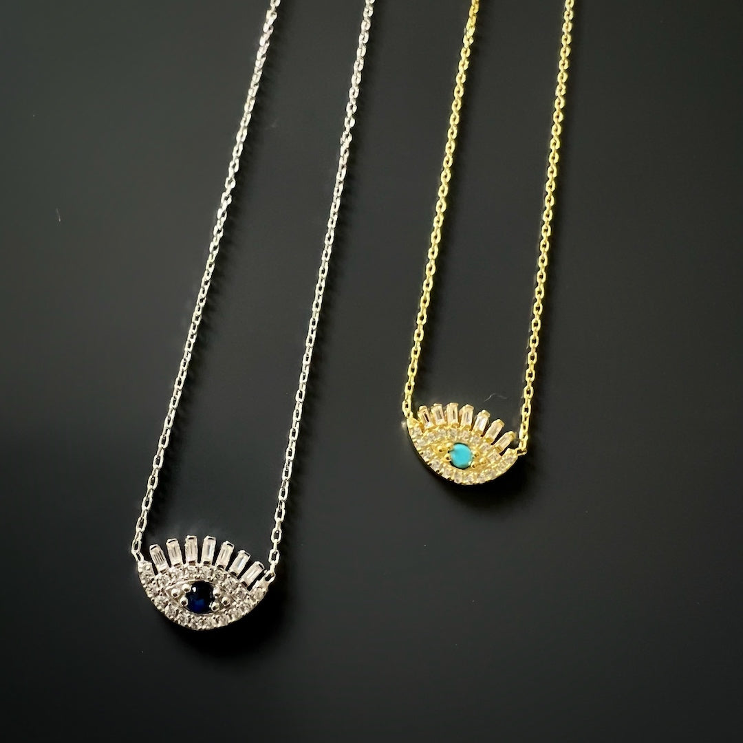 Close-up of the 18K gold plated Diamond Long Lash Necklace with turquoise stone and zircon accents, showcasing its stunning design.