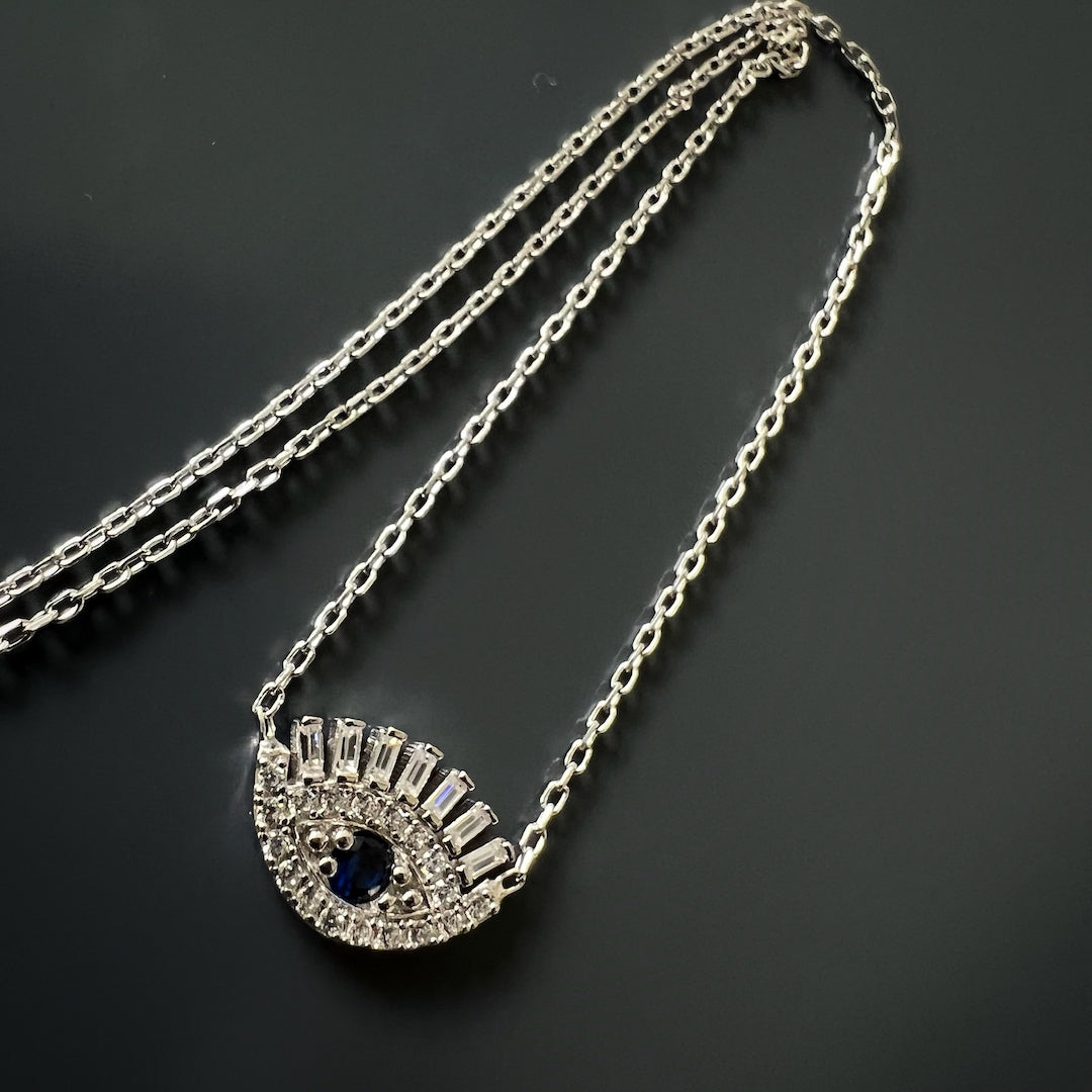 Sapphire and zircon stone details on the Diamond Long Lash Necklace, offering a touch of elegance and spirituality.