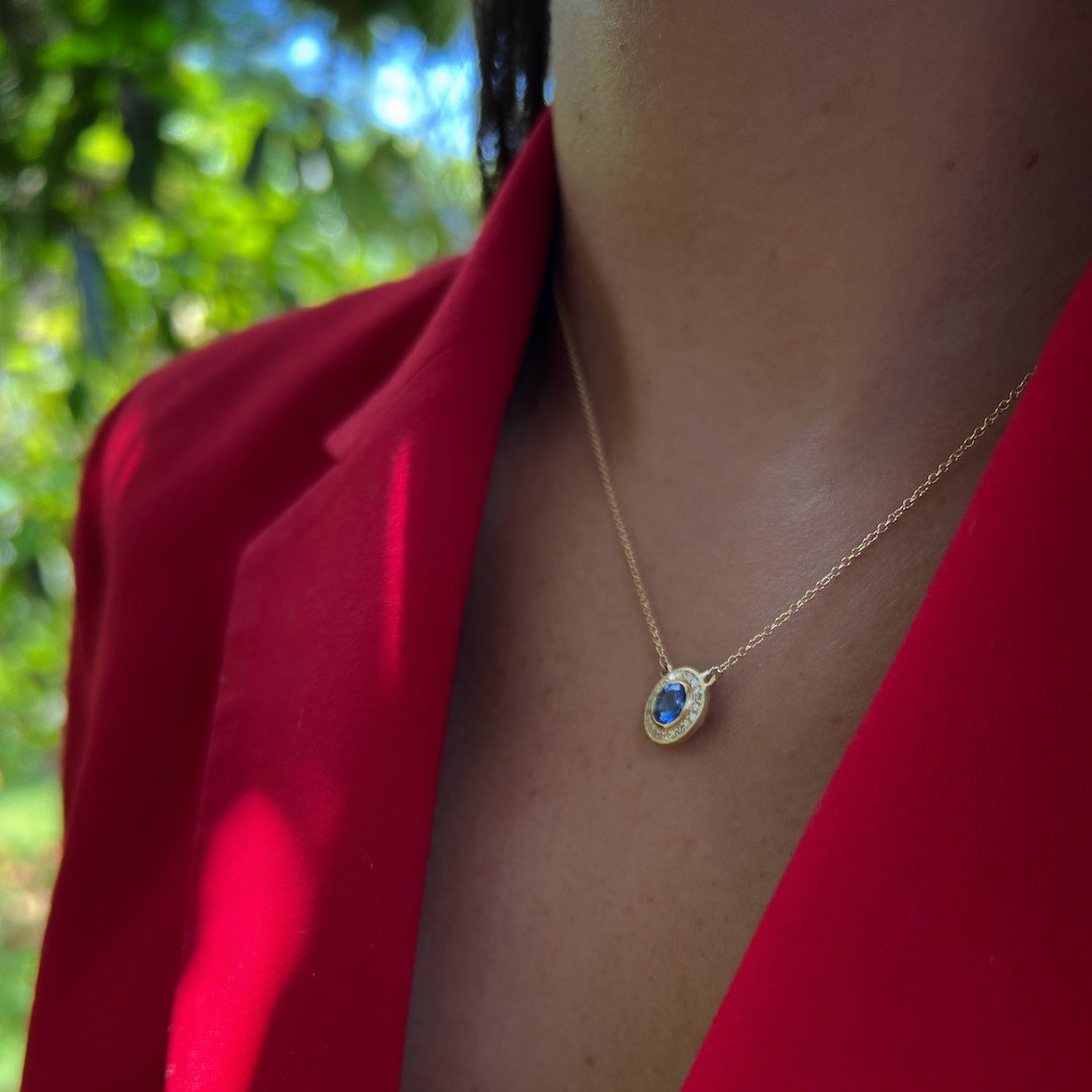 The Elegant Sapphire Necklace beautifully adorning the model's neckline, symbolizing royalty and abundance with its exquisite sapphire and shimmering diamonds.