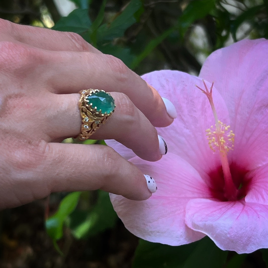 Hand model showcasing the Emerald & Diamond Teardrop Ring, symbolizing fidelity and true love with its stunning emerald centerpiece and the sparkle of diamonds, a perfect statement piece for any occasion.