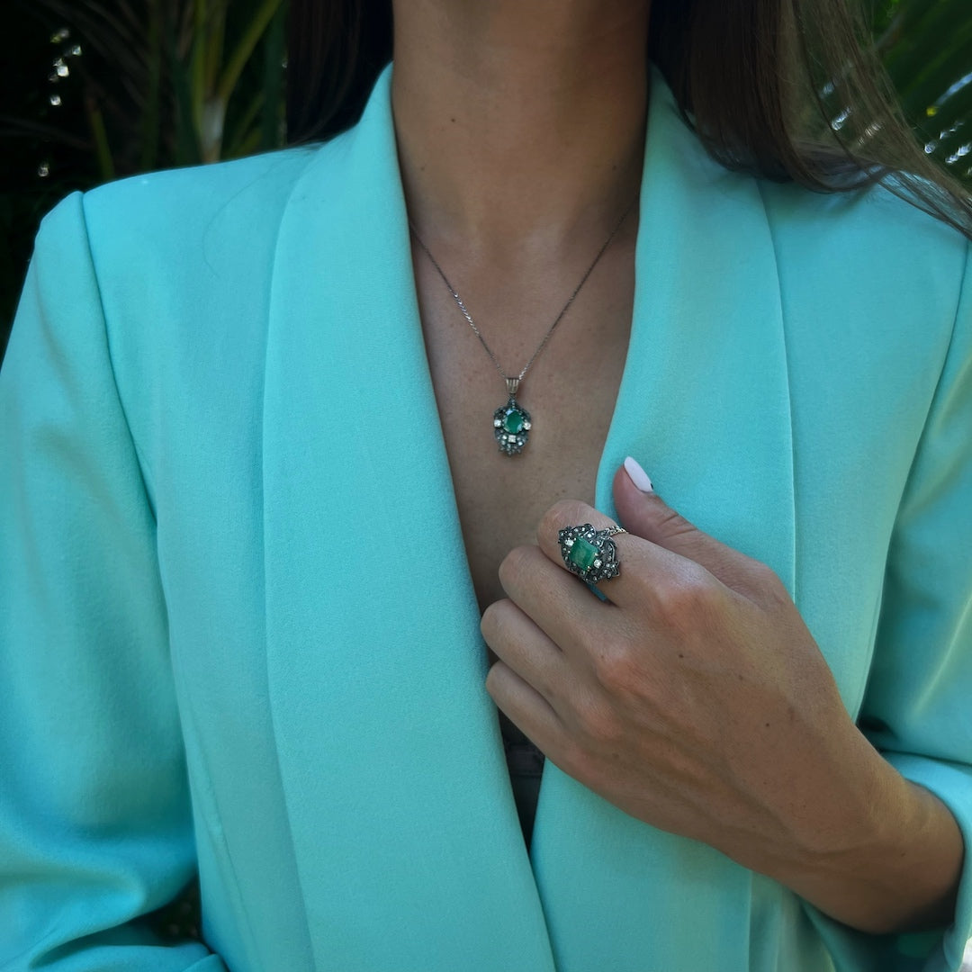 Hand model proudly displaying the Emerald Vintage Ring, a stunning combination of rose gold and silver surface, adorned with a dazzling emerald and delicate diamonds, adding a touch of sophistication and charm to any ensemble.