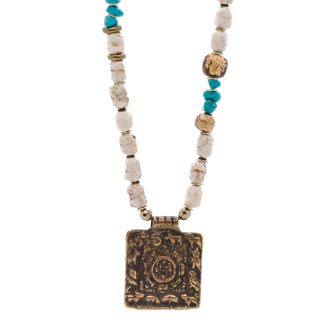 Ethnic Nepal Om Necklace - A stunning necklace that showcases the rich cultural heritage of Nepal. Featuring traditional Nepal meditation beads, vibrant turquoise beads, and a handmade Om Mantra pendant, this necklace is a unique and meaningful piece of jewelry.