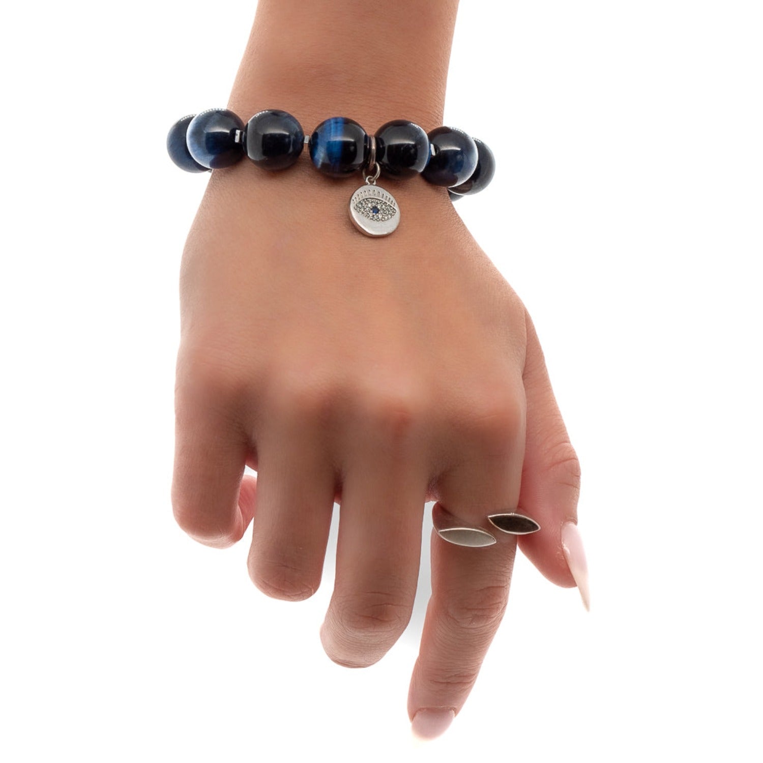 The model&#39;s wrist is adorned with the striking Power Of Eye Bracelet, a perfect accessory to make a statement.