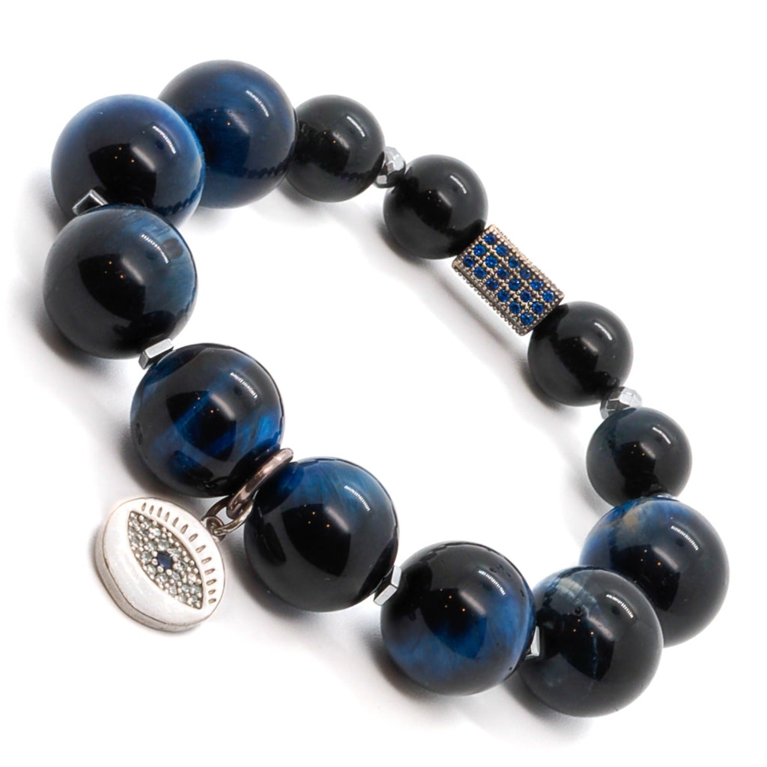 Make a bold statement with the Power Of Eye Bracelet, a unique accessory crafted with Blue Tiger&#39;s Eye stone beads and a zircon-adorned evil eye charm.