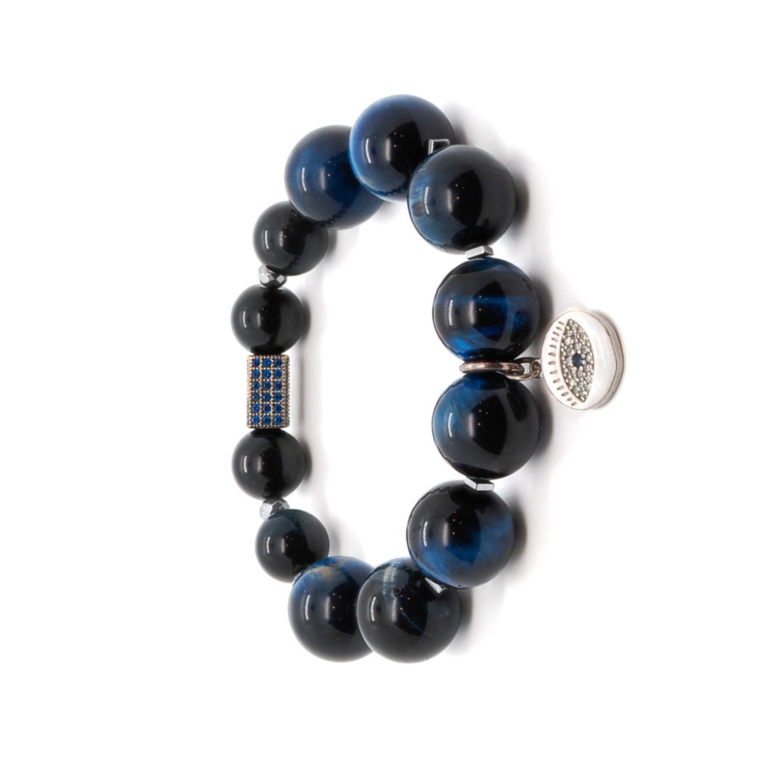 Elevate your look with the Power Of Eye Bracelet, a symbol of strength and protection that combines Blue Tiger&#39;s Eye stone beads and a sparkling Swarovski crystal accent bead.