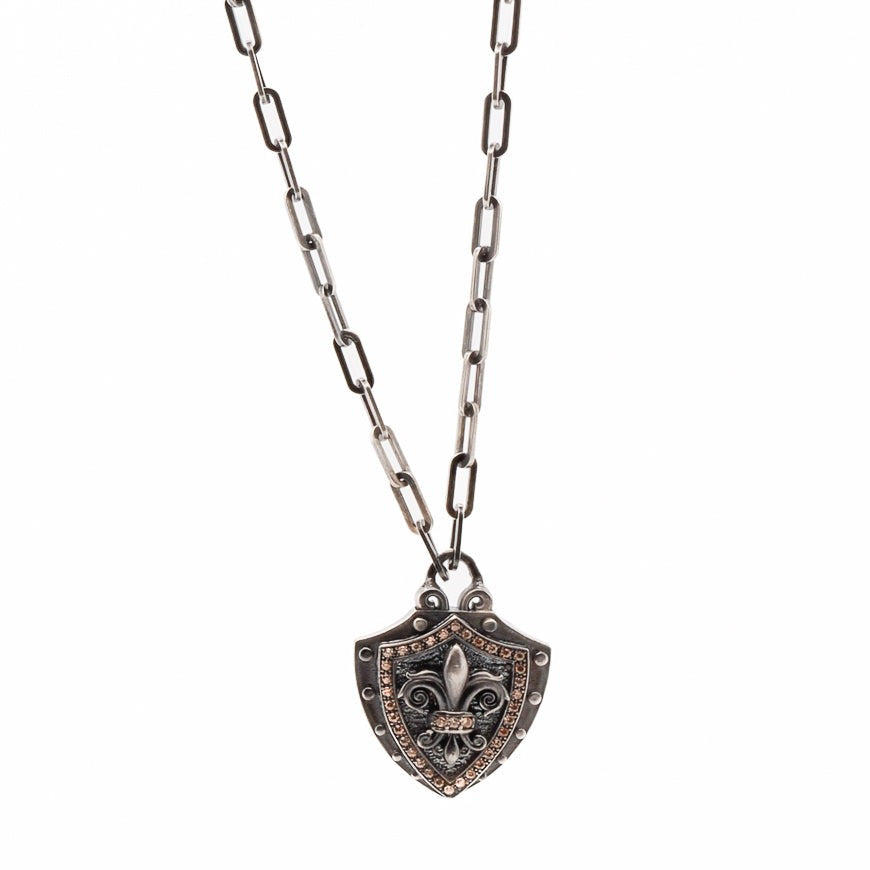 Fleur de Lis Shield Necklace - Handcrafted jewelry with a bold and unique Fleur de Lis shield pendant, made of 925 silver with brown zircon stones.