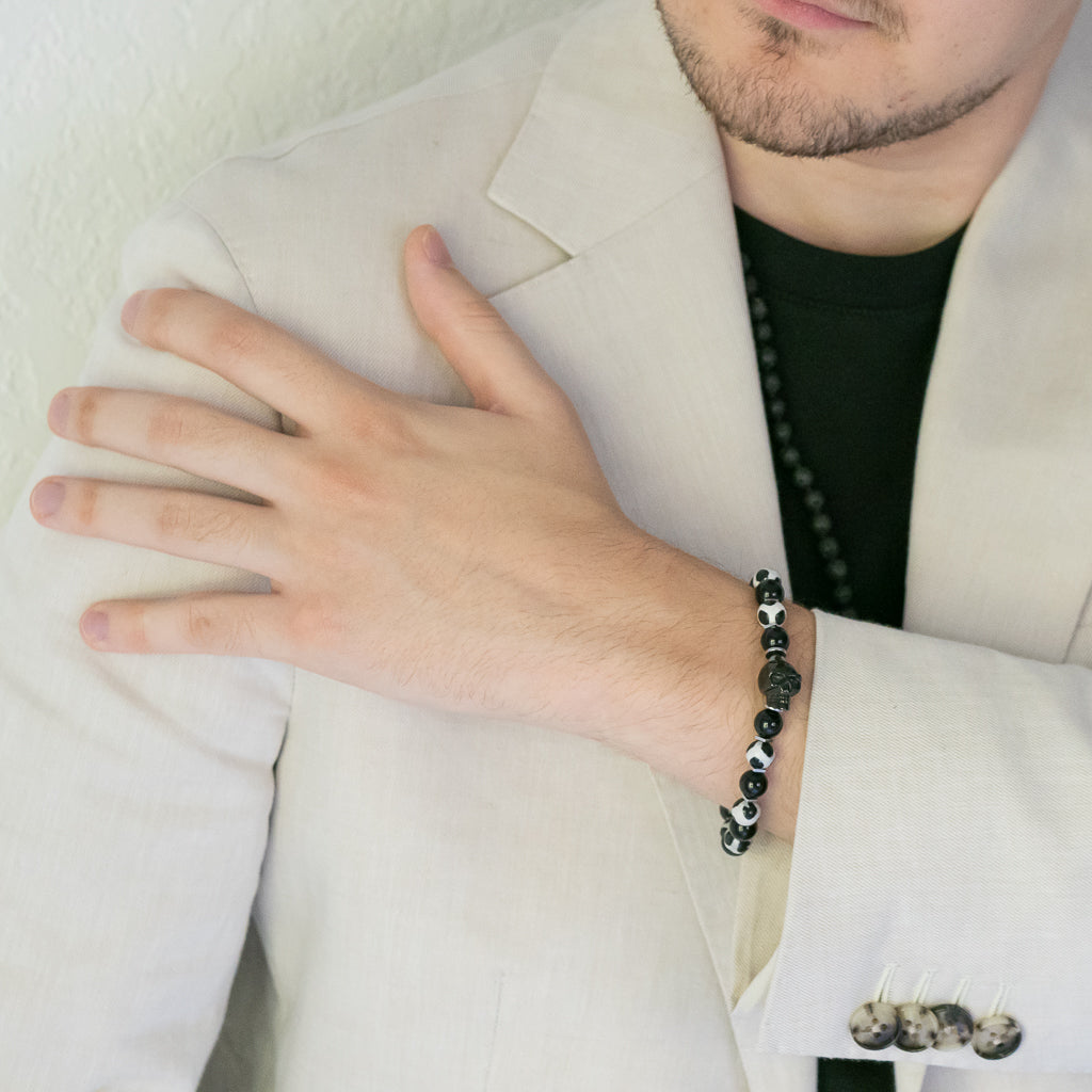 Gambler&#39;s Lucky Dice Skull Bracelet - Model showcasing a handcrafted bracelet with Black Onyx and Nepal agate beads, adorned with a black steel skull accent for a bold and daring look.