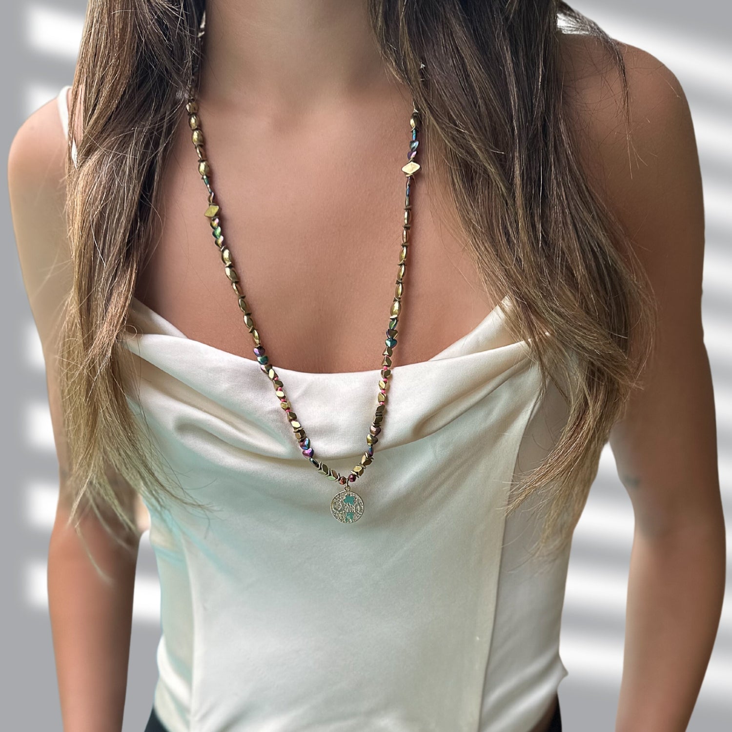 Model Wearing Gold Good Luck Symbol Necklace - A model showcasing the elegant and meaningful Gold Good Luck Symbol Necklace.