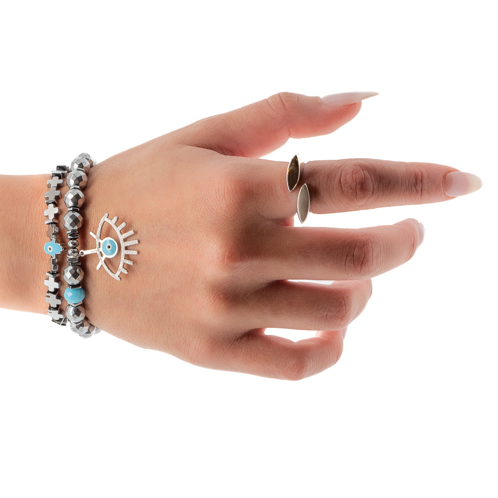 Hand model wearing the silver hematite stone beads bracelet with turquoise evil eye charm and navy blue/turquoise Hamsa charm
