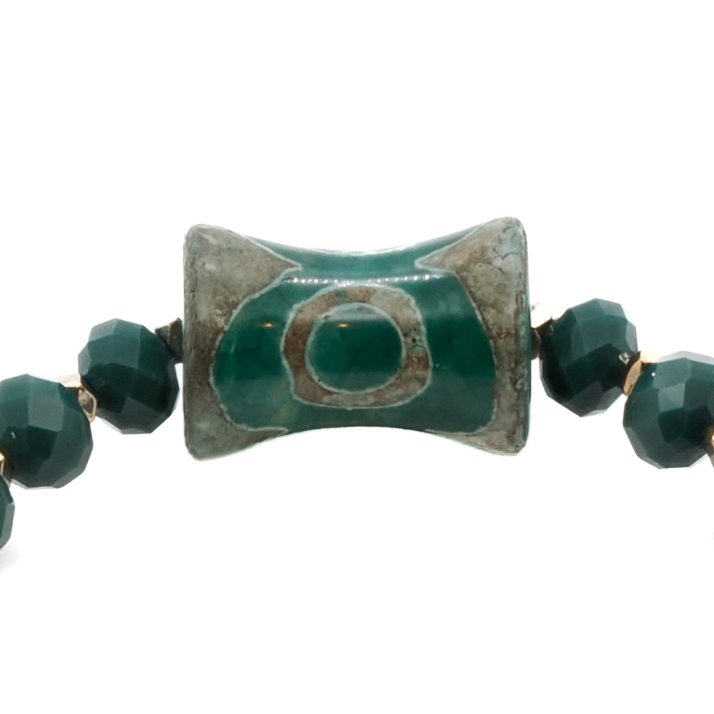 A detailed view of the Green Spiral Bracelet, focusing on the intricate design of the big green eye Nepal bead. 