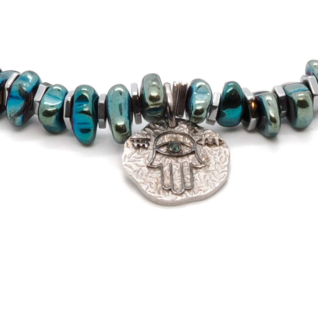 The combination of the green nugget hematite beads and the silver hematite spacers creates a stylish and eye-catching design, while the Hamsa charm adds a symbolic element to the bracelet.