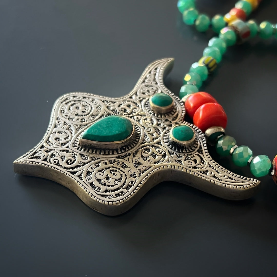 A combination image showing the necklace&#39;s teal crystal beads, silver hematite stone spacers, and coral rondella beads, capturing the varied textures and colors that add depth and character to the piece.