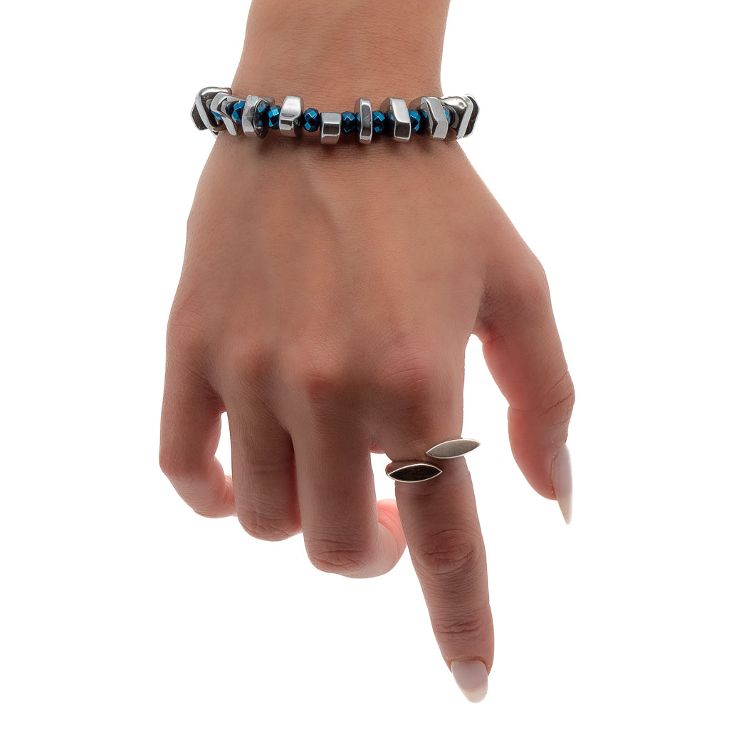 Explore balance and style with the Hematite Bracelet, as seen on a hand model, featuring its calming silver and blue hues.