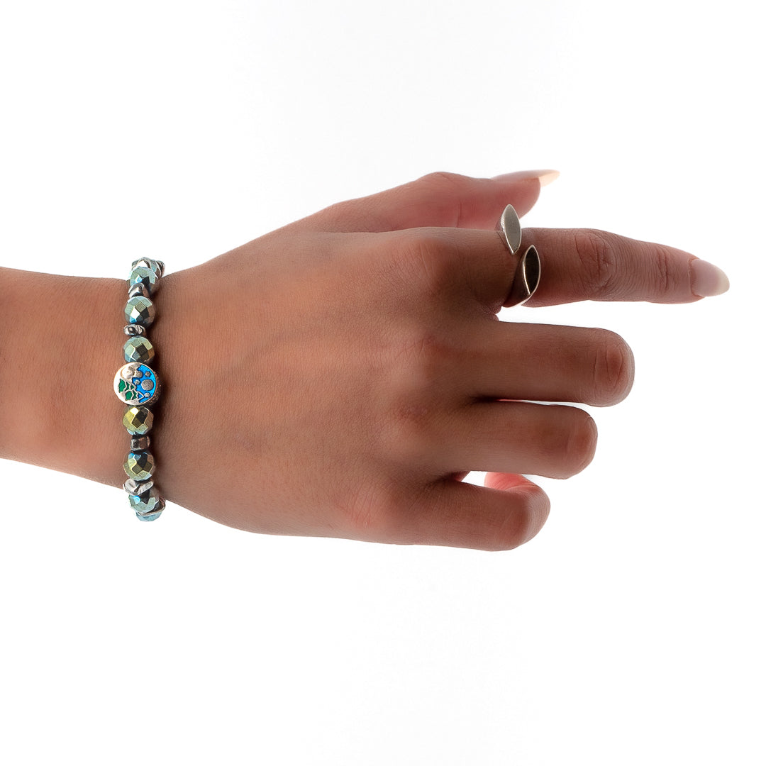 Hand model wearing the Hematite Energy Bracelet, showcasing its minimalist design and grounding Hematite gemstones.