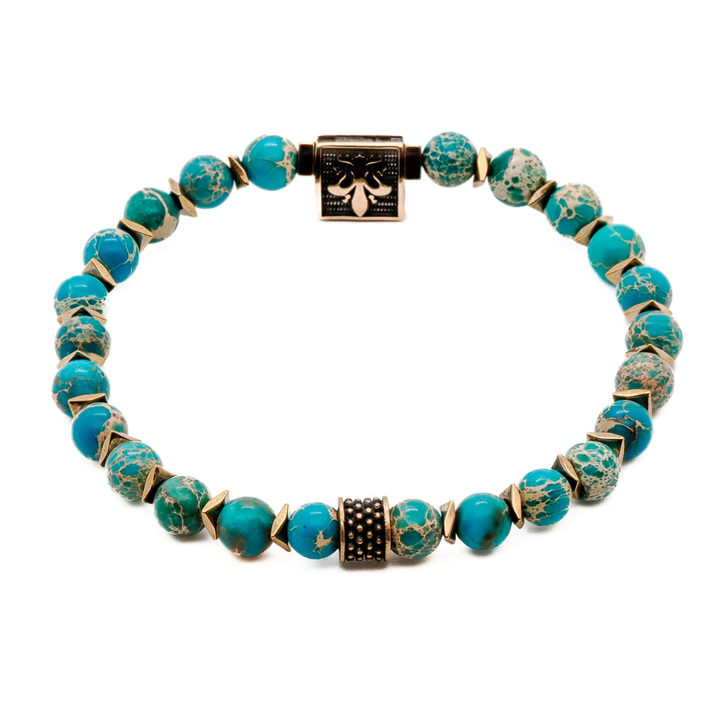 A symbolic bracelet with Blue Variscite stone beads and a Bronze gold-plated Fleur de lis accent bead, promoting inner peace and harmony.