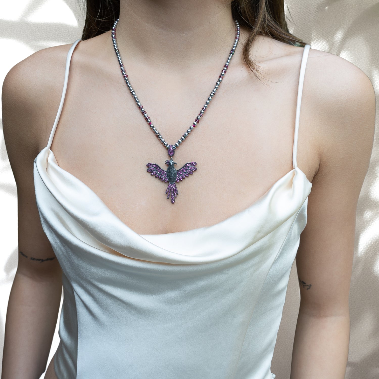 The Inner Rebirth Phoenix Necklace, worn by a model, radiating strength and rebirth.