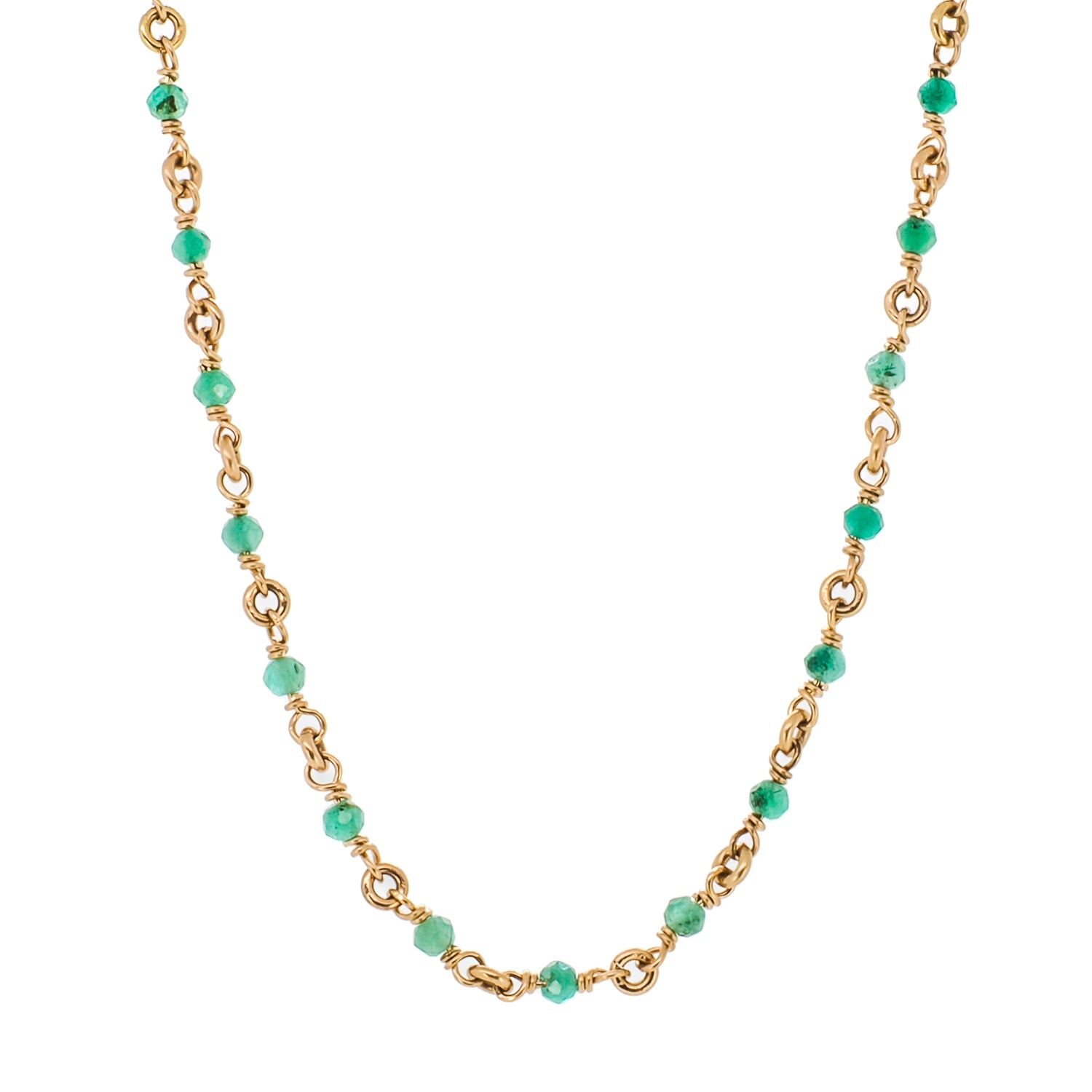 The Karya Jade Gold Necklace, featuring a 14-carat yellow gold eye pendant adorned with various natural stones, adding a touch of elegance and style.