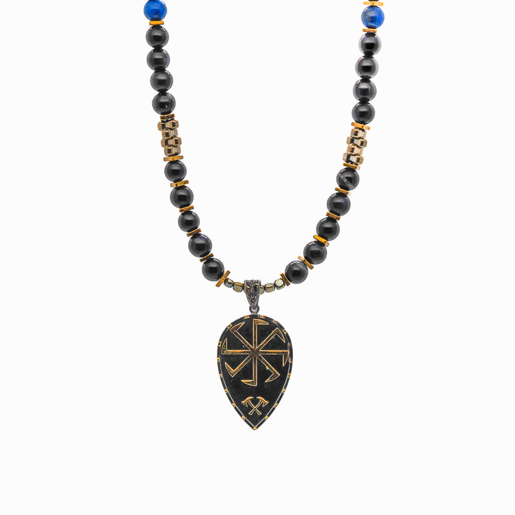 The Kolovrat Sun Cross Necklace elegantly draped, combining the natural beauty of the tiger&#39;s eye and lapis lazuli stone beads with the timeless charm of the gold-plated sun cross pendant.