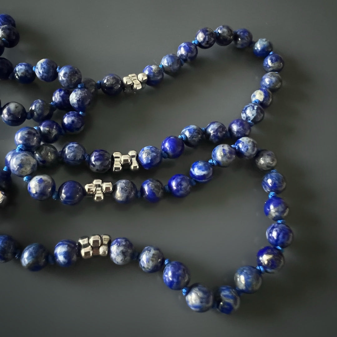 Vibrant Lapis Lazuli Beads and Wolf Pendant on a stylish necklace.