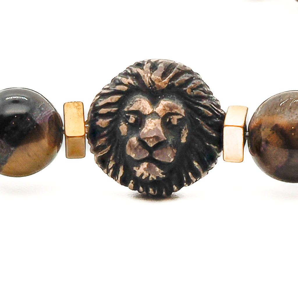 Channel your inner lion with the Lion Men Bracelet, showcasing Tiger's eye stone beads and a bronze Fleur de li bead for a touch of regal elegance.