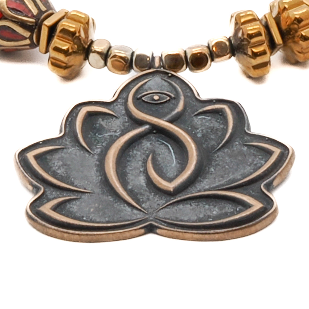 Connect with inner peace and strength with the Lotus Flower Mantra Bracelet, showcasing a meaningful mantra bead and a Lotus Flower charm.