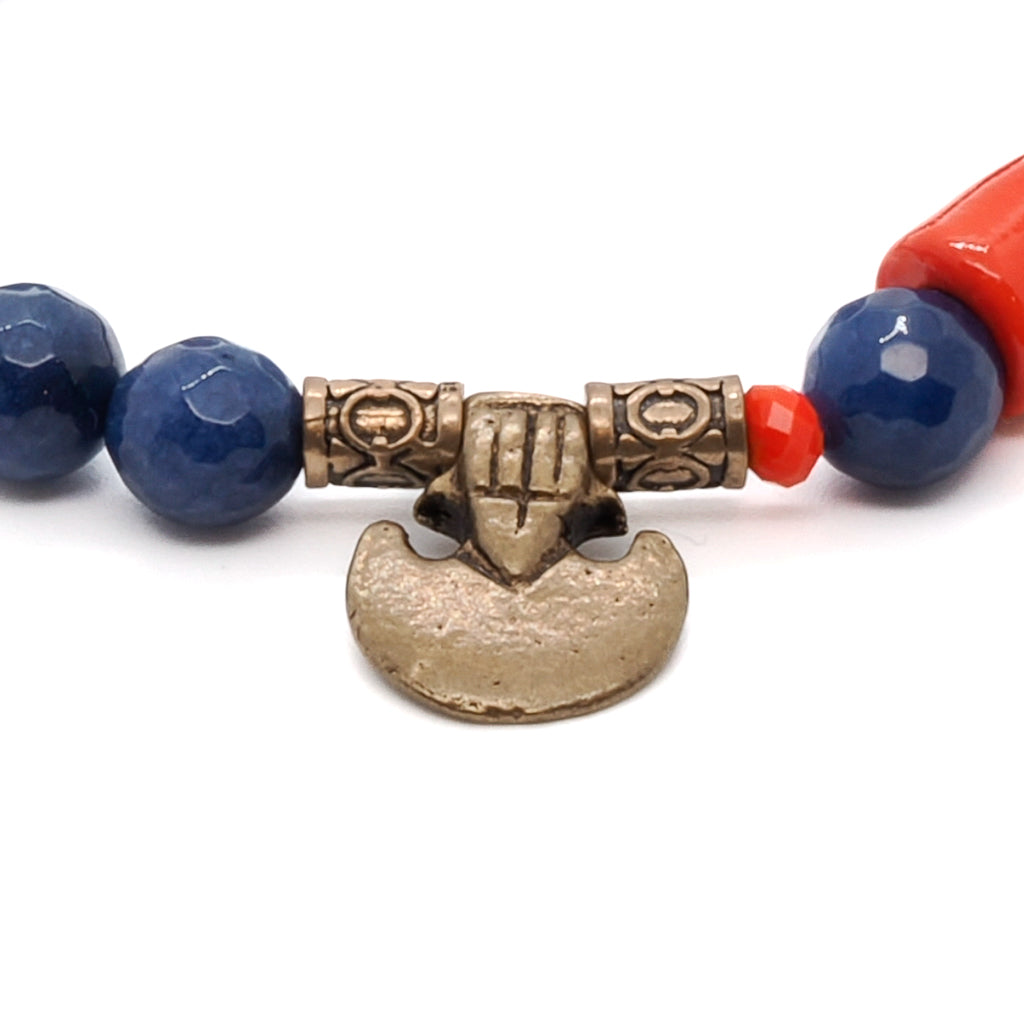 Experience the bold energy of the Martial Bracelet, showcasing Blue Agate and Orange Crystal beads with a striking Red focal bead and Bronze details.