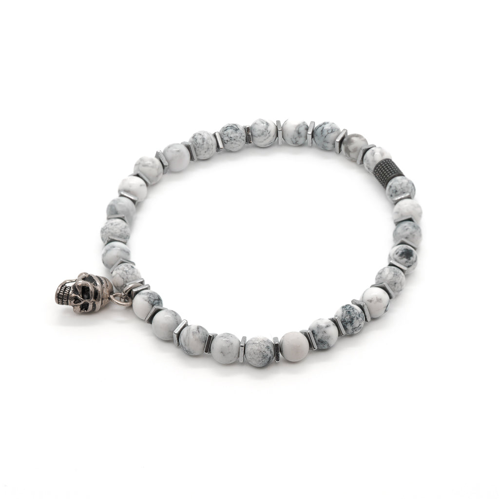 Embrace spirituality and style with the Men&#39;s Spiritual Beaded Skull Bracelet, featuring White Howlite stone beads and a Sterling Silver skull charm.