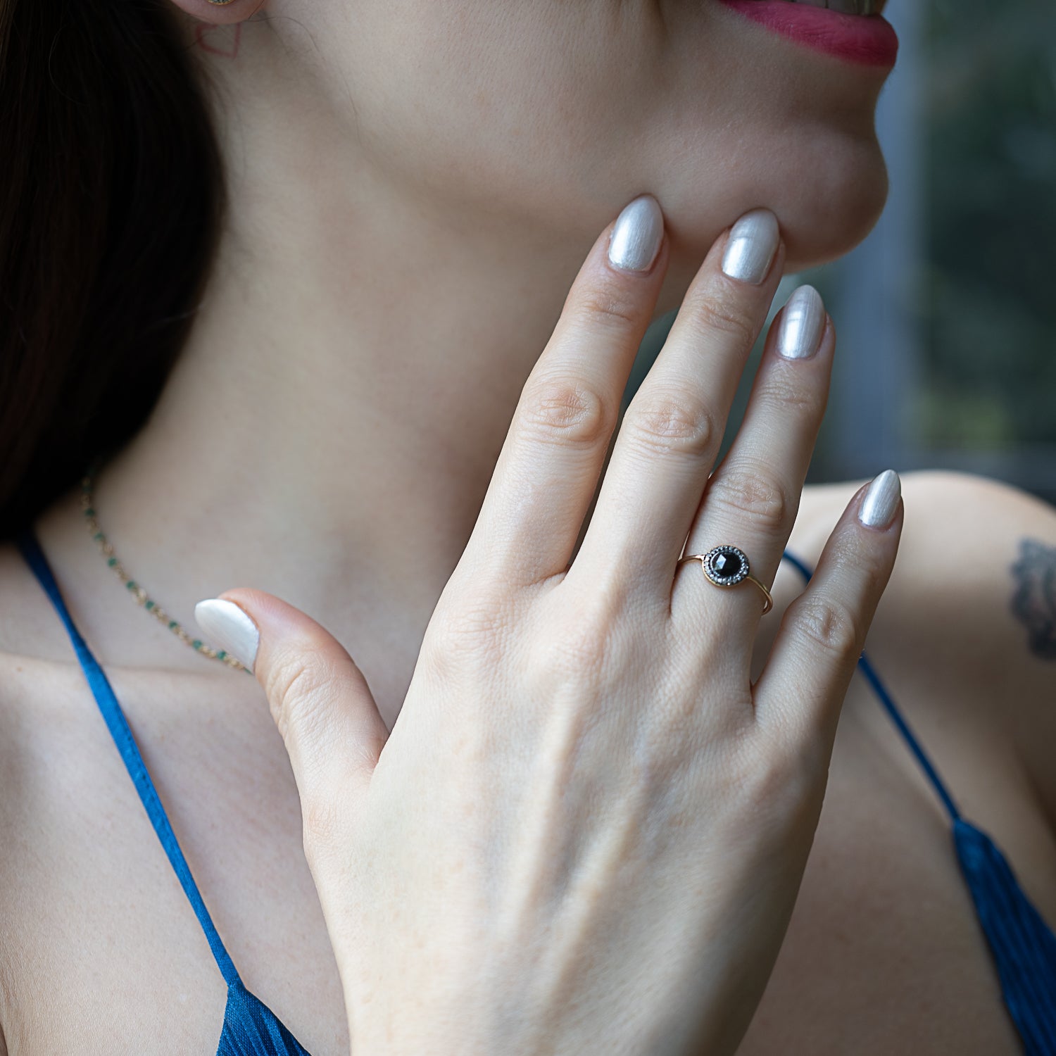 Model showcasing the elegance of the Mini Black Rose Cut Ring on her finger.