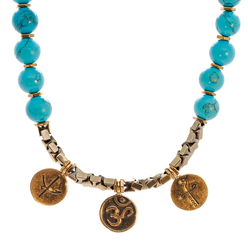 Close-up of the Mystic Meditation Necklace, showcasing the vibrant turquoise stone beads and symbolic charms.