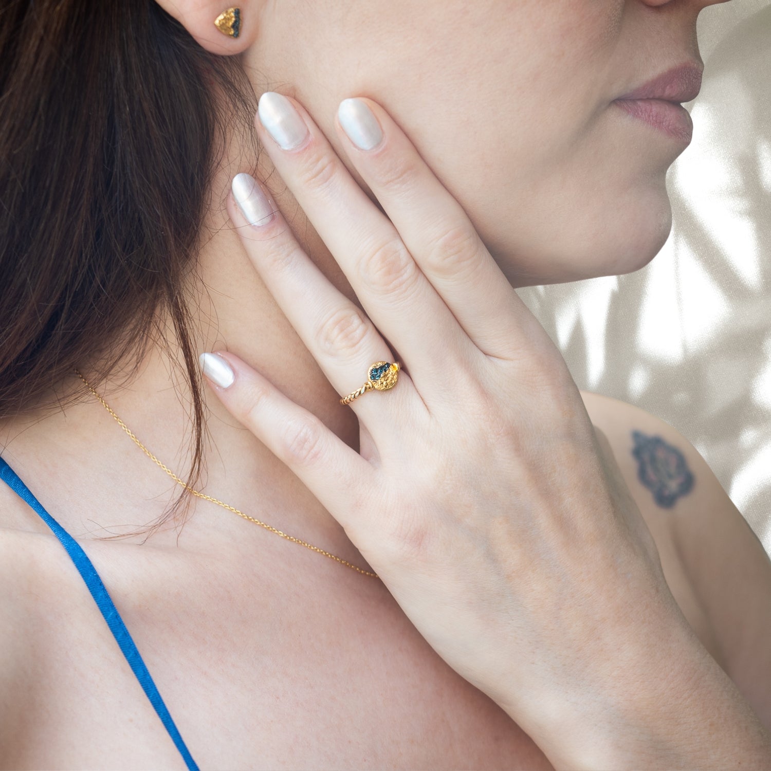 Model wearing the Nature Round Twisted Gold Diamond Ring, showcasing its unique twisted band and the beauty of the petroleum diamonds.