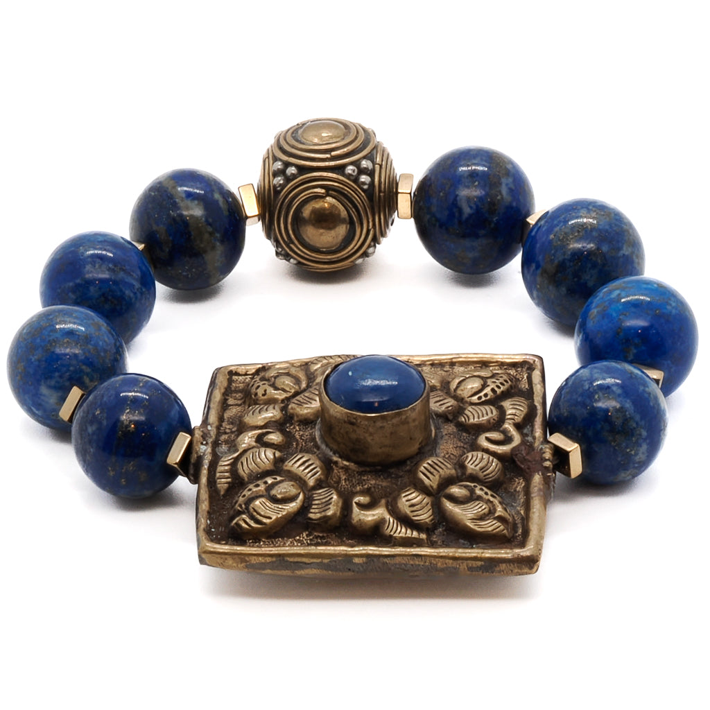 Find beauty and meaning in the Nepal Energy Bracelet, featuring 14mm lapis lazuli beads and a handmade brass piece from Nepal.