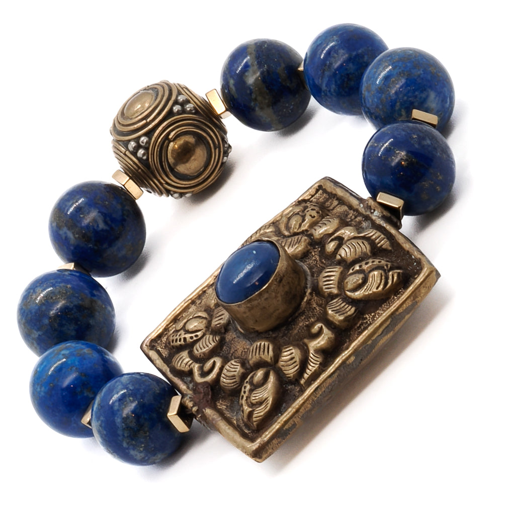 Experience the craftsmanship of Nepal with the Nepal Energy Bracelet, showcasing a chunky brass piece and lapis lazuli stone.