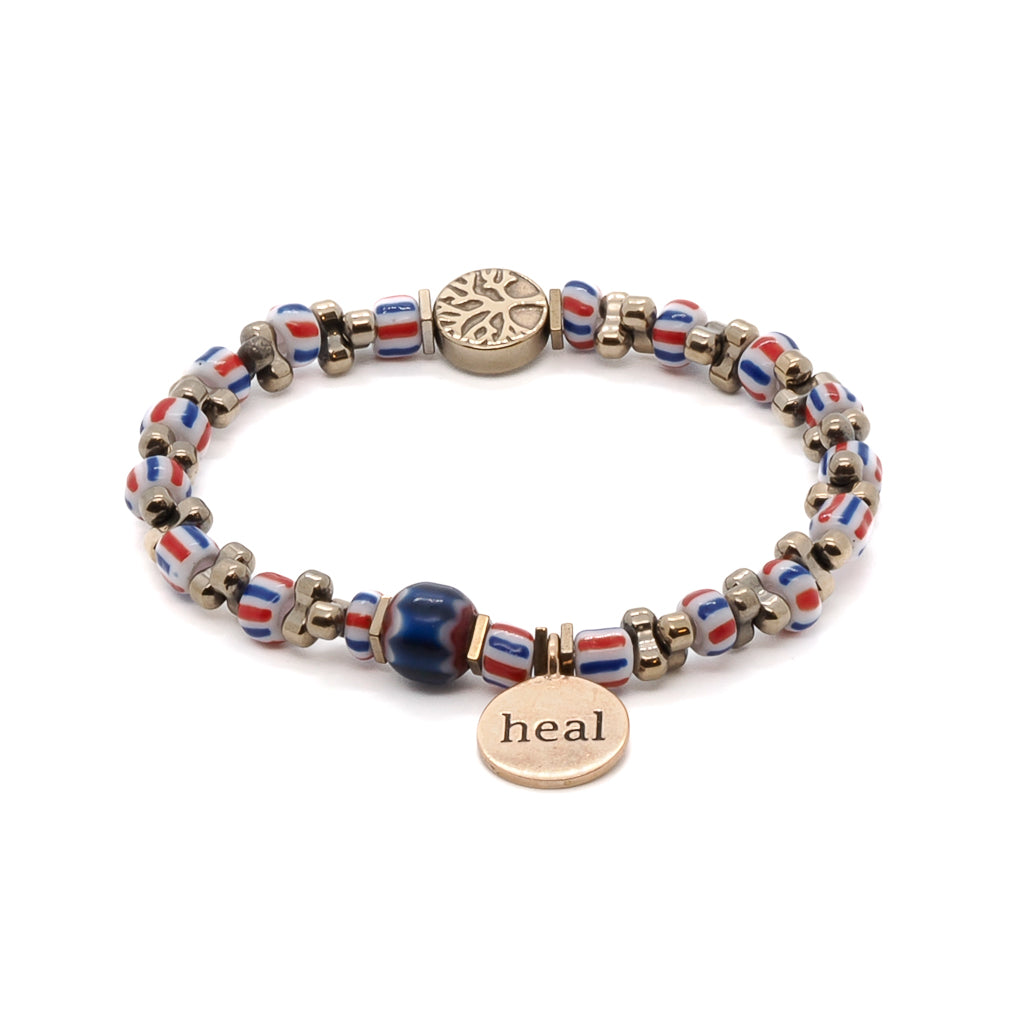 Embrace the spiritual symbolism of the Nepal Heal Bracelet, featuring a bronze heal charm and a striking hematite tree of life bead.