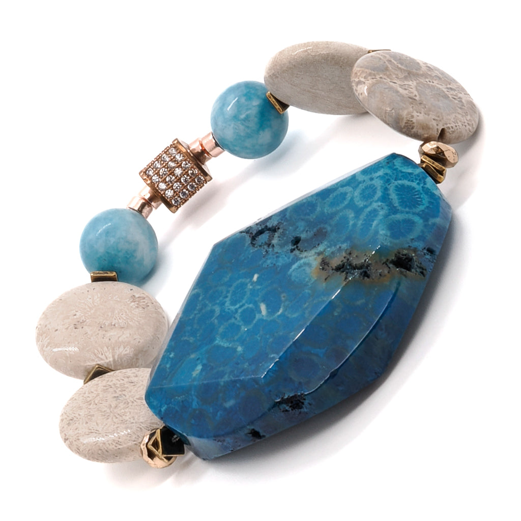 Embrace the elegance of the New World Bracelet, featuring harmonious blue agate gemstone beads and gold hematite spacers.