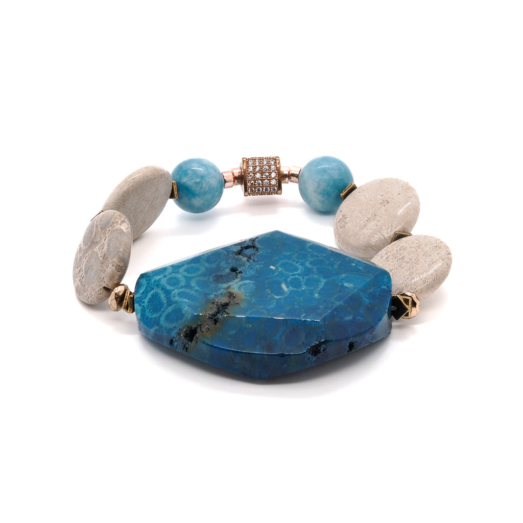 Discover the beauty of the New World Bracelet, adorned with blue agate gemstone beads and a flat round jasper stone centerpiece.