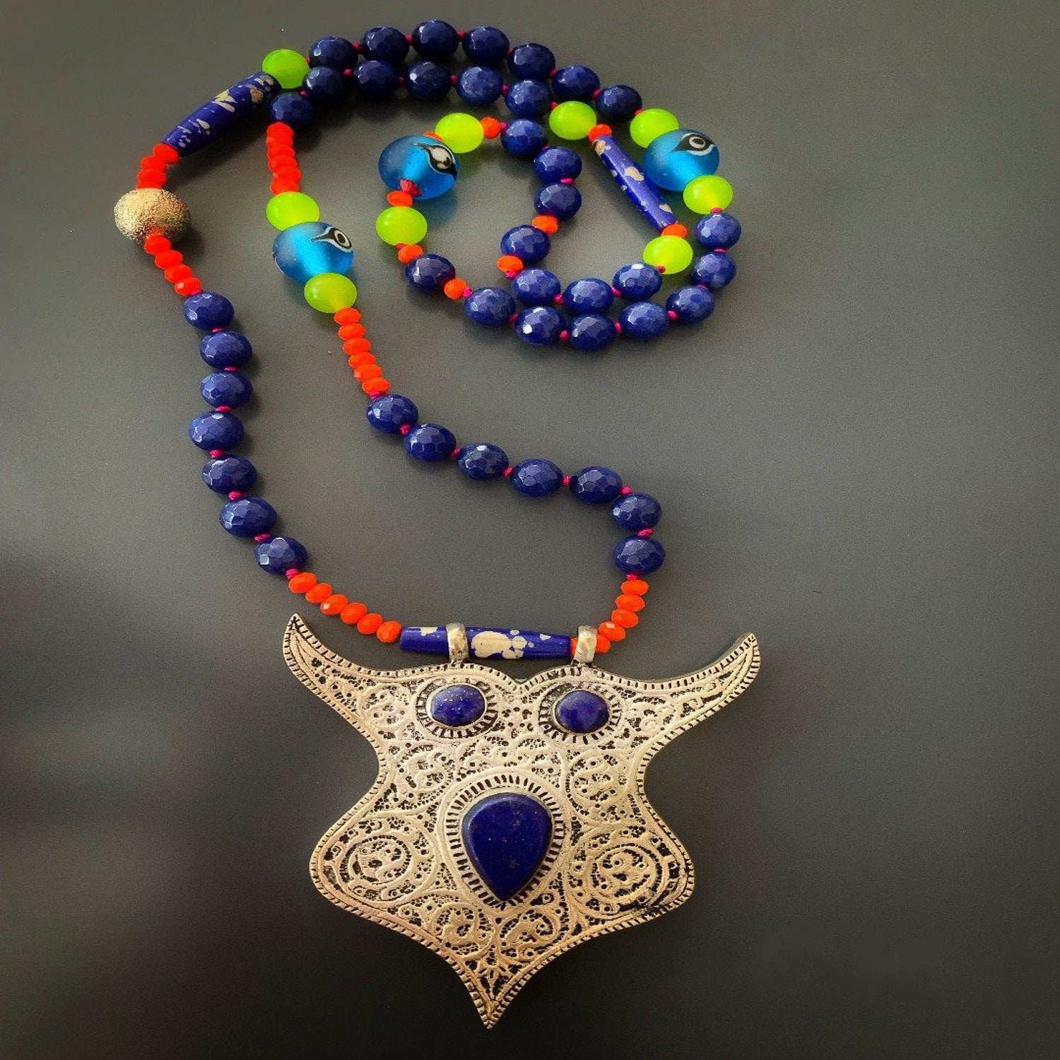 Embrace the mystical allure of the Night Owl Necklace, featuring a striking combination of jade and Lapis Lazuli.