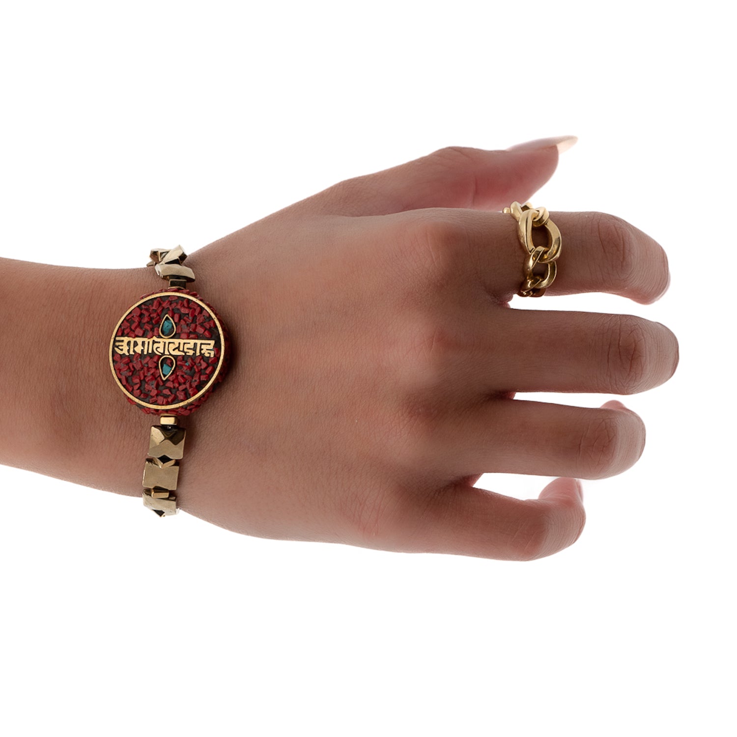 The hand model wears the Om Mani Padme Hum Coral Mantra Bracelet, showcasing its spiritual symbols and stylish design.