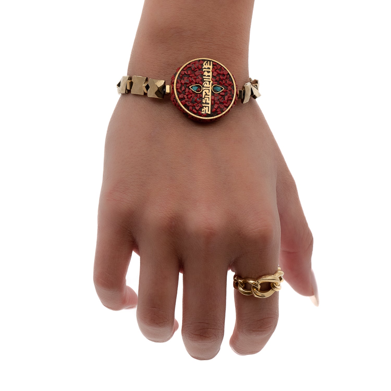 See the Om Mani Padme Hum Coral Mantra Bracelet on the hand model&#39;s wrist, radiating spiritual energy and protection.