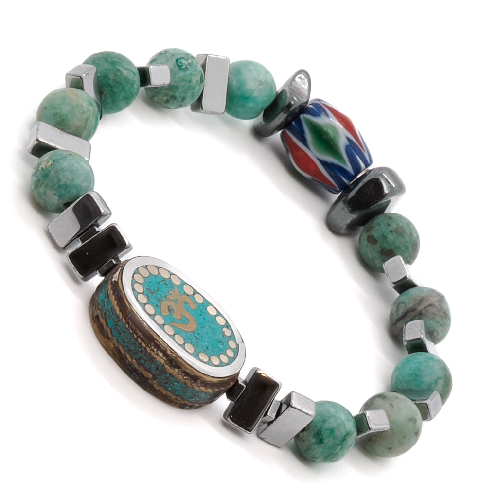Admire the intricate details of the Om Mystic Bracelet, showcasing its 8mm green African turquoise stone and colorful African bead.