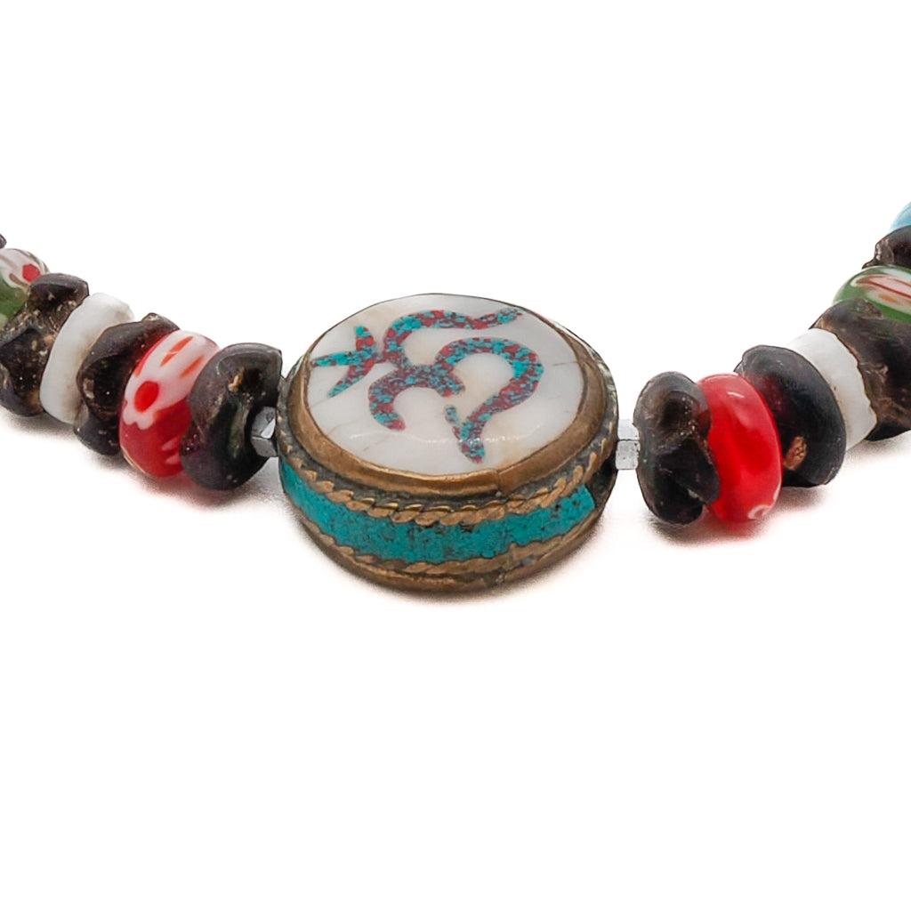 Embrace the harmonious design and spiritual energy of the Om Yoga Ankle Bracelet, adorned with Mille Fiori Glass beads and a handmade white howlite and turquoise stone OM bead.