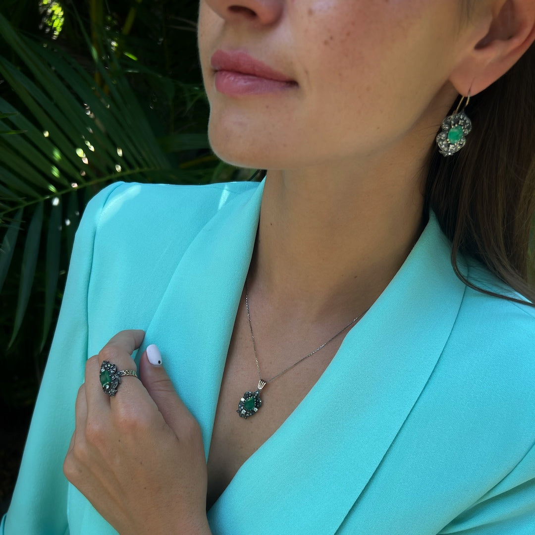 Radiant Beauty - The emerald and diamonds shine on the model&#39;s neckline.