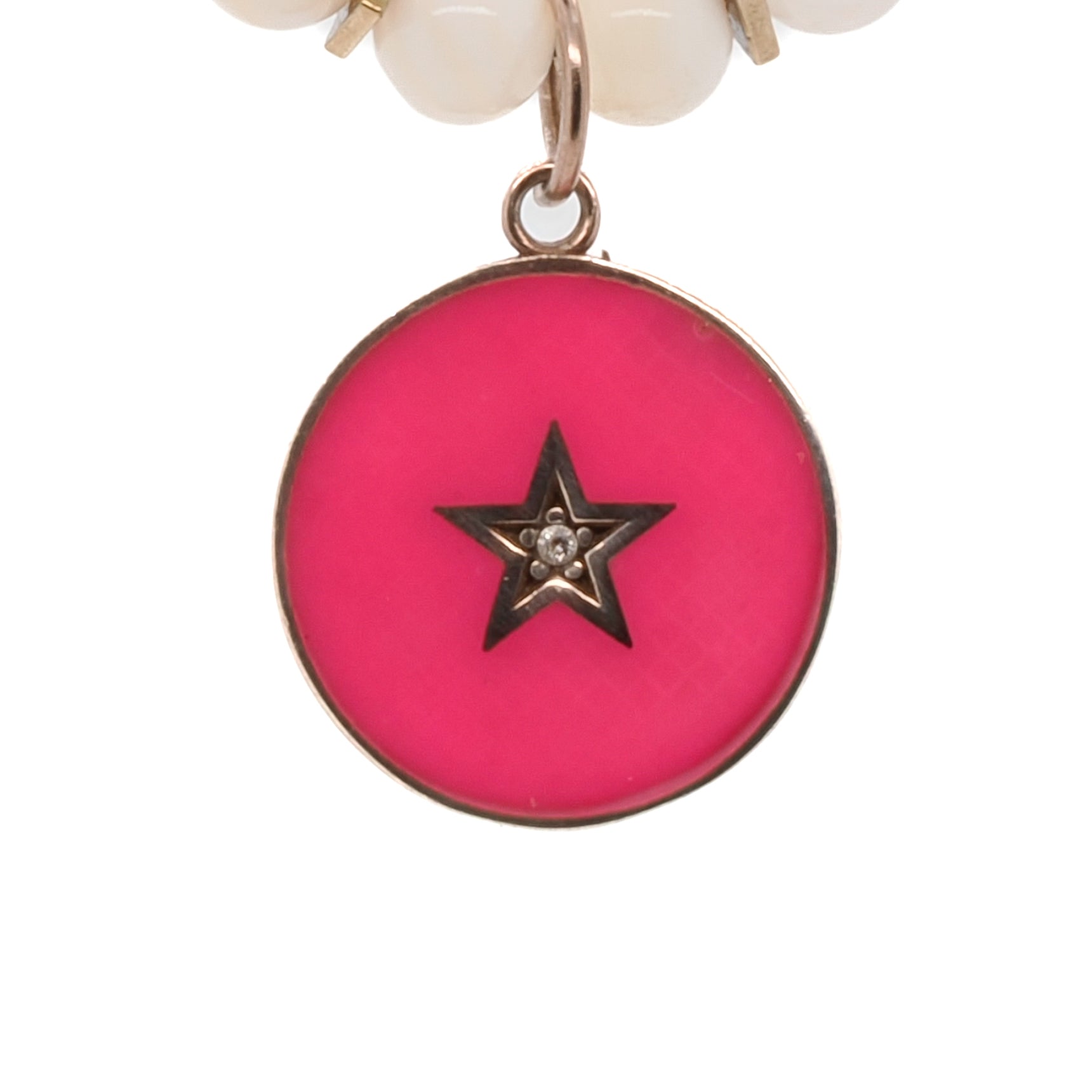 Illuminate your style with the Pink Star White Choker Necklace, a dazzling piece adorned with gold hematite spacers and a pink enamel star charm.