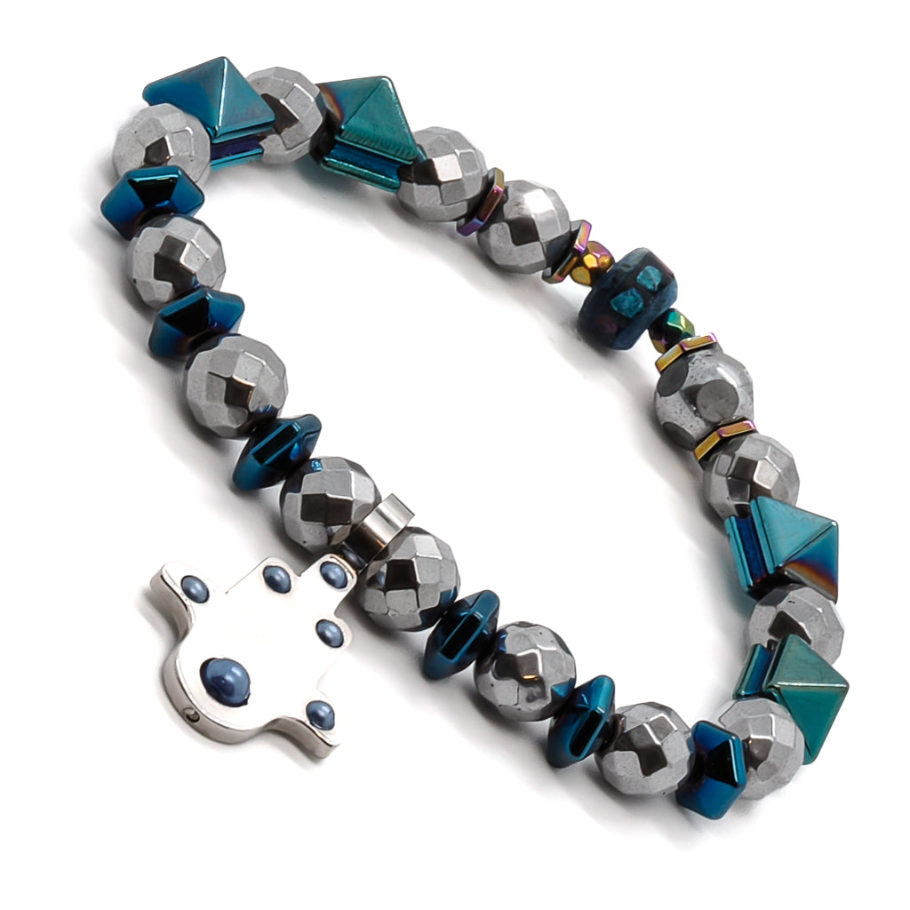 Experience the spiritual essence of the Positive Hamsa Bracelet, adorned with silver hematite beads, blue hematite pyramid beads, and a protective Hamsa charm.