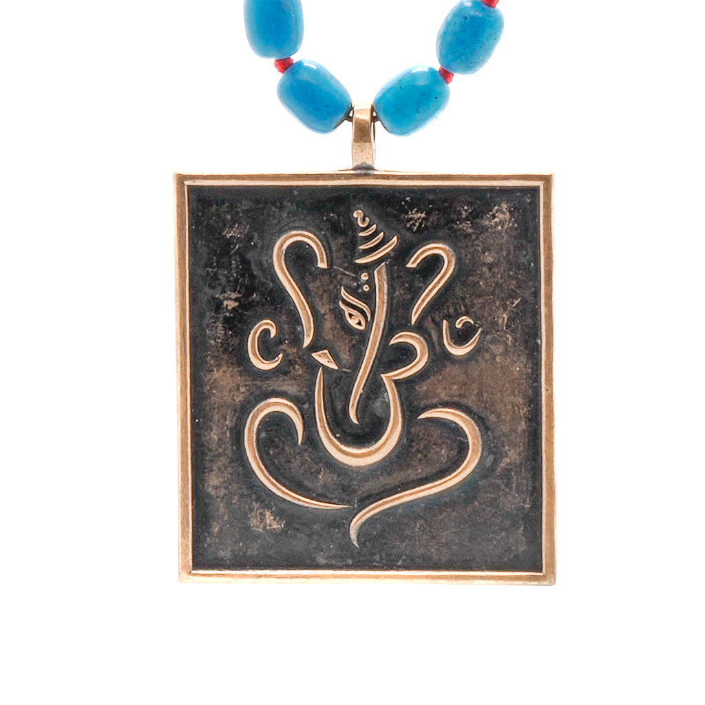 Turquoise necklace with Ganesha and Buddha pendant, a symbol of positive energy and spiritual guidance.